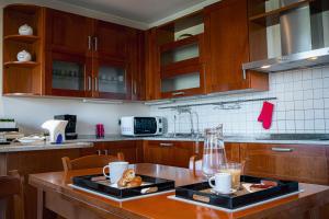 a kitchen with wooden cabinets and a table with food on it at Agri Alloggio Poggiolina in Bagnara di Romagna