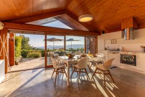 a kitchen and dining room with a table and chairs at Bagoada Cabin - Sunset Vista - uChill in Vila Nova de Cerveira