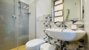 a bathroom with a sink and a toilet and a shower at Albergo Villa Denny in Rimini +79 photos