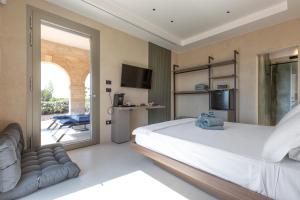 a bedroom with a bed and a sliding glass door at Bed & Mare by Perle di Puglia in Baia Di Gallipoli