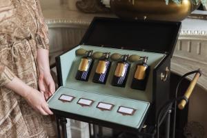a woman holding a box full of bullets at Waldorf Astoria Amsterdam in Amsterdam