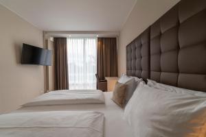 Postel nebo postele na pokoji v ubytování Pakat Residences
