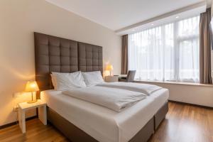 Postel nebo postele na pokoji v ubytování Pakat Residences