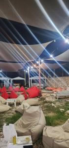 a large tent with many pillows on the grass at iCampJal Beach Camp and Bar in Jal