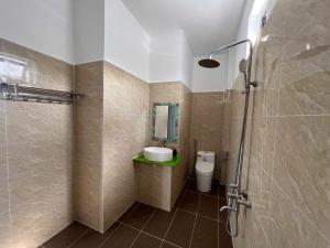 a bathroom with a sink and a toilet and a mirror at An Thới Ocean View - ẩn mình trên cao tầm nhìn ôm trọn biển in Phú Quốc