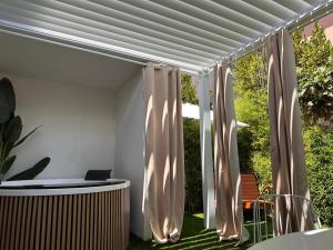 a white pergola with curtains in a yard at INsideOUT RELAX in Porto SantʼElpidio