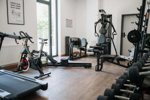 a gym with several exercise bikes in a room at Coffee Fellows Hotel München-Freiham in Munich