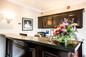 a kitchen with a counter with a vase of flowers on it at The Hotel Hollywood in Los Angeles
