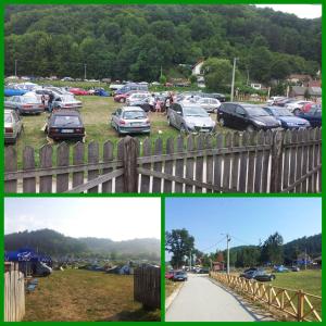 a group of cars parked in a parking lot at Etno konačište Protić, Guča in Guča