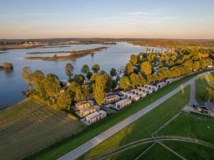 an aerial view of a house by a river at Luxurious holiday home nearby the Lower Rhine in Maurik