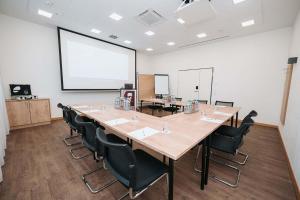 a large conference room with a large table and chairs at Coffee Fellows Hotel München-Freiham in Munich