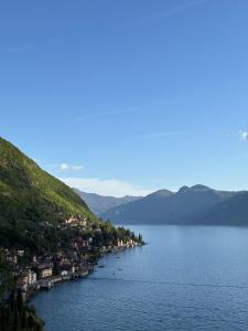 a large body of water with a town on the shore at Lake Como - Casa Mafy in Bellano