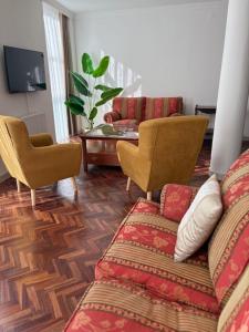 a living room with a couch and chairs and a table at Cardenal Centro in Monforte de Lemos