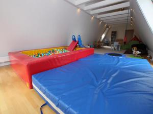 a room with a bed in a room with a play area at Ferienwohnung im Müritz Nationalpark in Mirow in Mirow