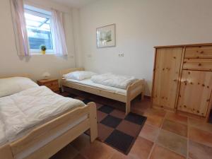a bedroom with two beds and a dresser and a window at Ferienwohnung im Müritz Nationalpark in Mirow in Mirow +35 photos