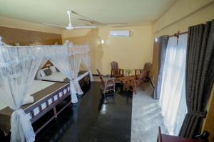 Postel nebo postele na pokoji v ubytování Manikgoda Tea Paradise New