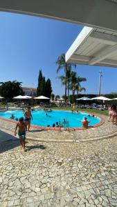 a group of people in a swimming pool at Hotel ausonia in Corigliano Calabro
