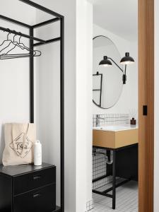 a bathroom with a sink and a mirror at Bob W Münchner Freiheit in Munich +24 photos