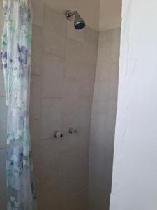 a bathroom with a shower with a shower curtain at Ruitersrust in Fauresmith +1 photo