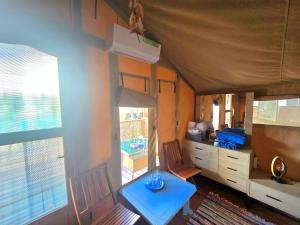 a small blue table in a room with a kitchen at Ioannina Camping- Glamping in Néon Bizánion