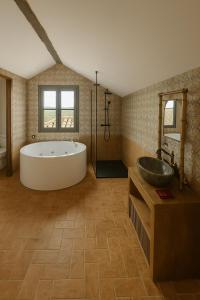 a large bathroom with a tub and a sink at Edennia I El Cielo en La Tierra in Mora