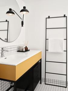 a bathroom with a sink and a mirror at Bob W Münchner Freiheit in Munich