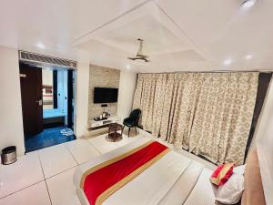 a bedroom with a bed with a red blanket at Hotel Kamakhya Inn in Chhatarpur