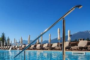 a swimming pool with chairs and umbrellas at Vista Villa at Katarino SPA in Bansko