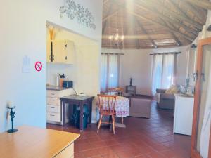 a kitchen and living room with a table and chairs at Toshi's Lodge in Hopewell