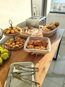 a table topped with baskets of bread and pastries at Hotel Gloria in Eforie Sud
