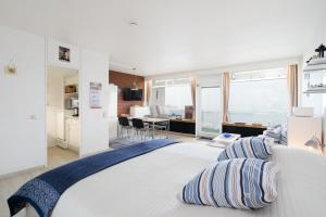 a bedroom with a large bed with pillows on it at Panoramic App B08-6 in Sierksdorf