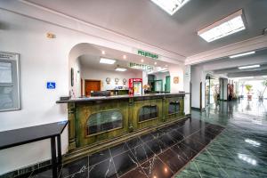 a lobby with a wooden counter in a building at Hotel Zdravets in Varna City +41 photos