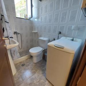 a white bathroom with a toilet and a sink at The Mastiha Spot 4 in Chios +23 photos