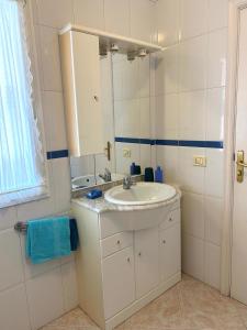 a white bathroom with a sink and a mirror at Veliero en Costa Sol M13 in Costa Del Silencio +14 photos