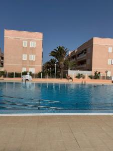 a large swimming pool in front of a building at Veliero en Costa Sol M13 in Costa Del Silencio