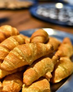 a pile of croissants on a plate on a table at Hotel Korali in Troulos