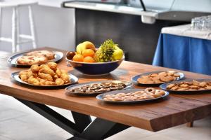 a wooden table with plates of food on it at Hotel Korali in Troulos
