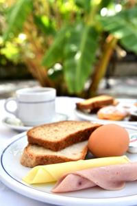 a plate of food with bread and eggs on a table at Hotel Korali in Troulos