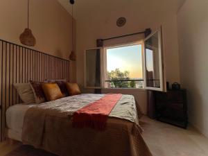 a bedroom with a bed and a large window at Le Moulin in Aix-en-Provence