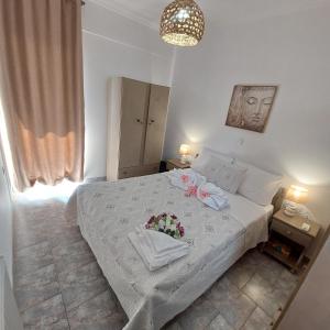 a bedroom with a white bed with flowers on it at The Mastiha Spot 4 in Chios