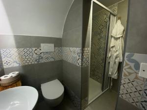 a bathroom with a toilet and a sink and a shower at La Casa della Pizzica in Ostuni