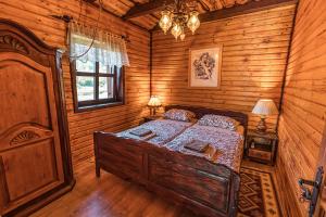 a bedroom with a bed in a log cabin at Villa Tara in Plaški +55 photos