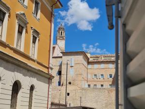 a building with a clock tower in the distance at Domi B & B in Macerata