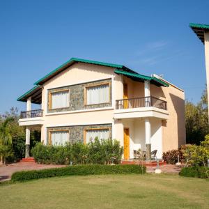 a large white house with a yard at Kudrat Resort-Jim Corbett in Kota Bāgh +41 photos