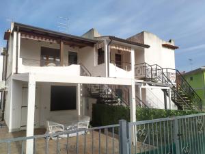 a white house with stairs and a balcony at Lidia in Rosolina +10 photos