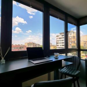 a laptop computer sitting on a desk in front of a window at Апартамент с една спалня в ценъра на града in Yambol +8 photos
