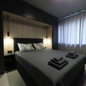 a bedroom with a bed with towels on it at Апартамент с една спалня в ценъра на града in Yambol