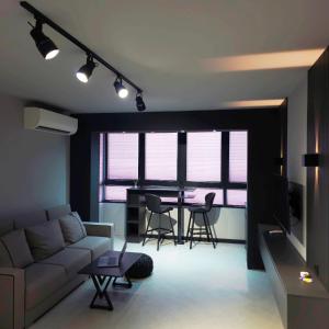 a living room with a couch and a table with chairs at Апартамент с една спалня в ценъра на града in Yambol