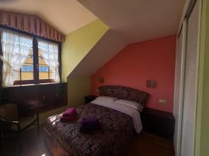 a bedroom with a bed with purple towels on it at Apartamento Tere in Llanes