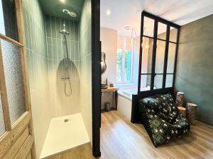 a bathroom with a shower and a bench in a room at Craft Home - Le menuisier - Balneo - Parking privé in Saint-Étienne